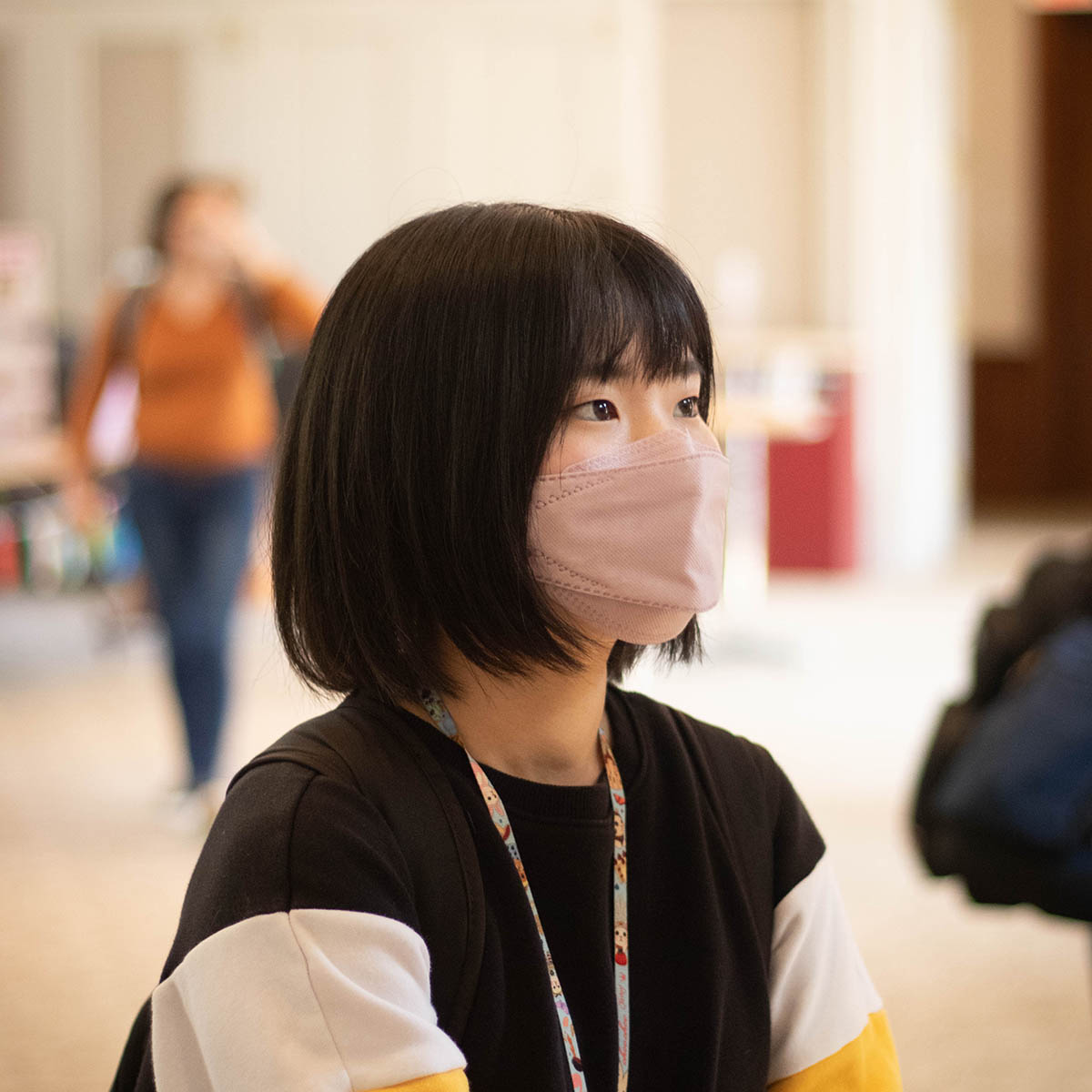 Photo of a student at an international event, wearing a mask