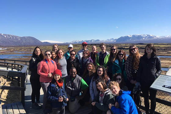 Photo of of a group of Chatham University student posing in front of mountains in Iceland.