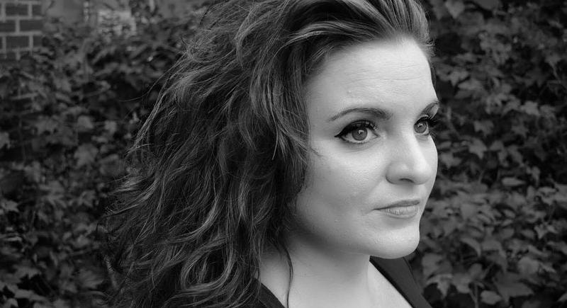 Black and white profile of woman with dark hair and eyeliner. 