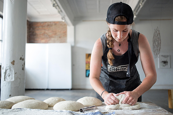 Photo of Shauna Kearns, MAFS '15 kneading bread dough