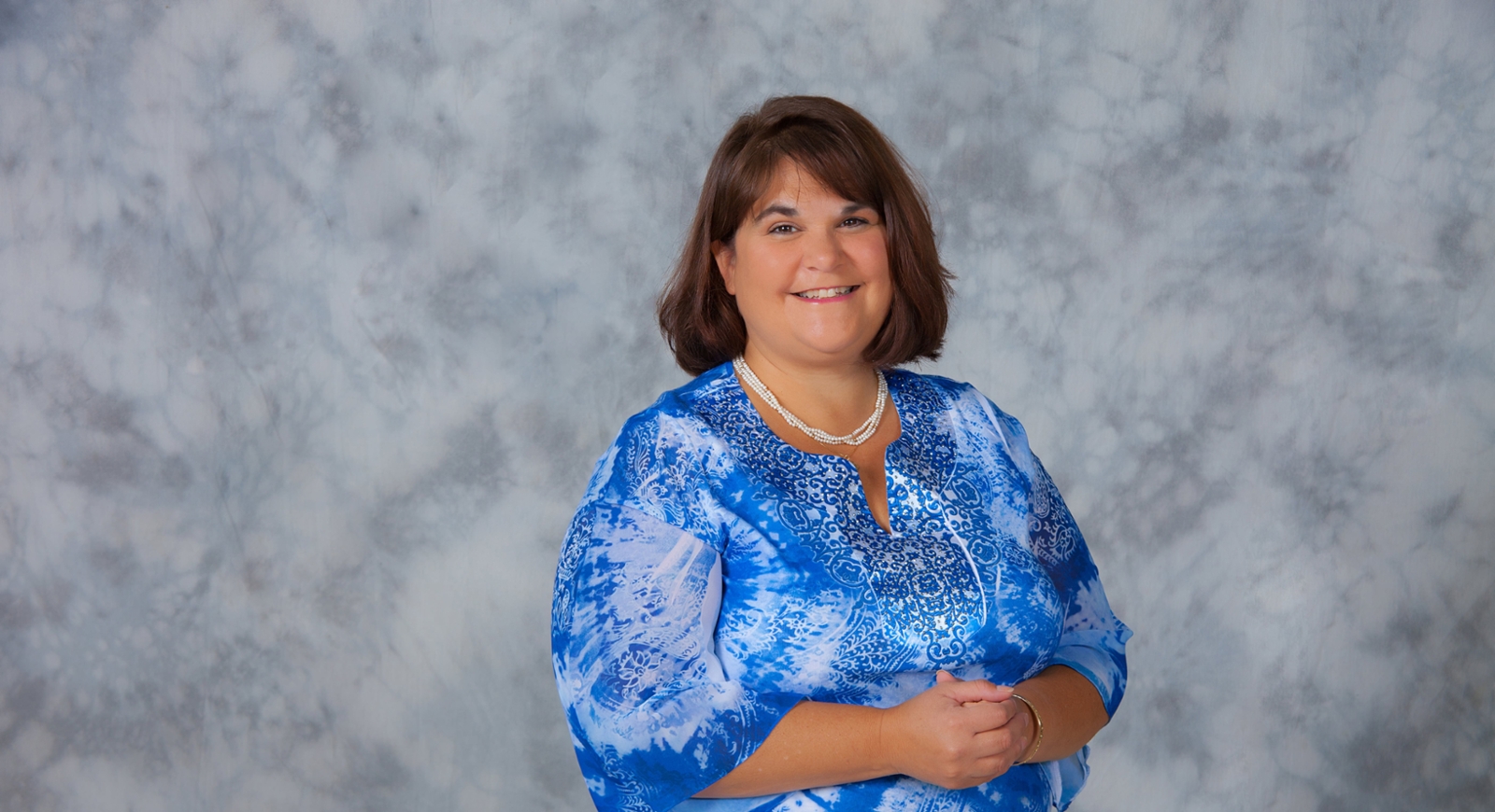 Professional photo of Kristin Harty, Chatham University in front of a grey background