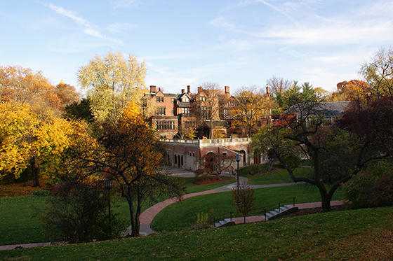 Photo of Mellon Hall on Chatham University, surrounded by green academic quads and colorful fall foliage.