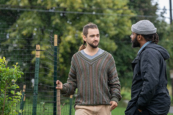 Sustainability student speaks with a faculty member on Eden Hall Farm