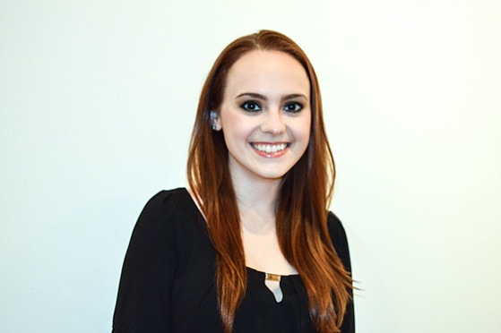 Photo of a smiling Chatham University female student standing in front of a white background