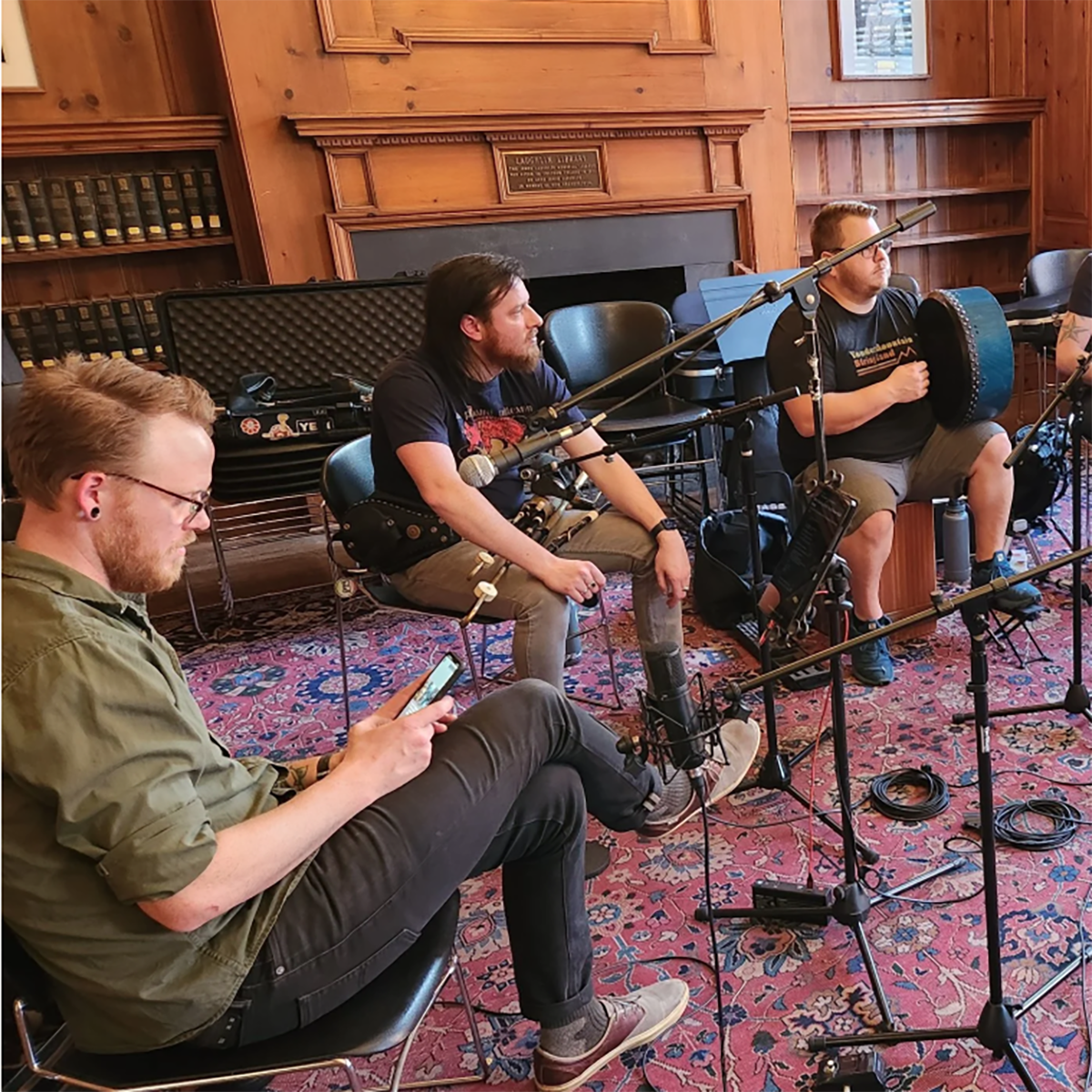 William Thomas ’26 adjusts a microphone stand as the folk band Bealtaine waits to record a song. (Courtesy of Dan Eichenbaum)
