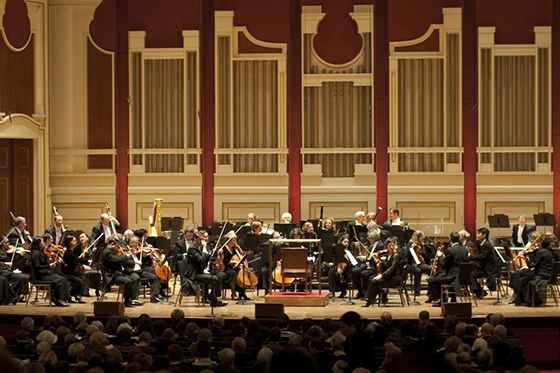 Photo of the Pittsburgh Symphony Orchestra performing on stage. 