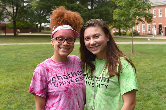 Photo of two women in Chatham University shirts smiling together