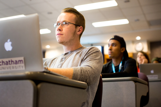 Photo of two Chatham University students paying attention to a lecture