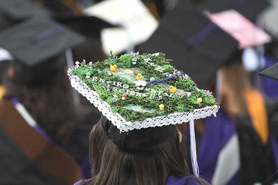 Three Chatham University graduates in gowns and caps pose for a photo