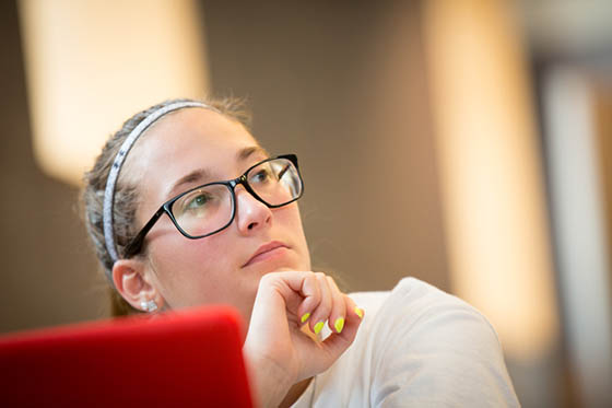Photo of a Chatham University female student paying attention to a lecture.