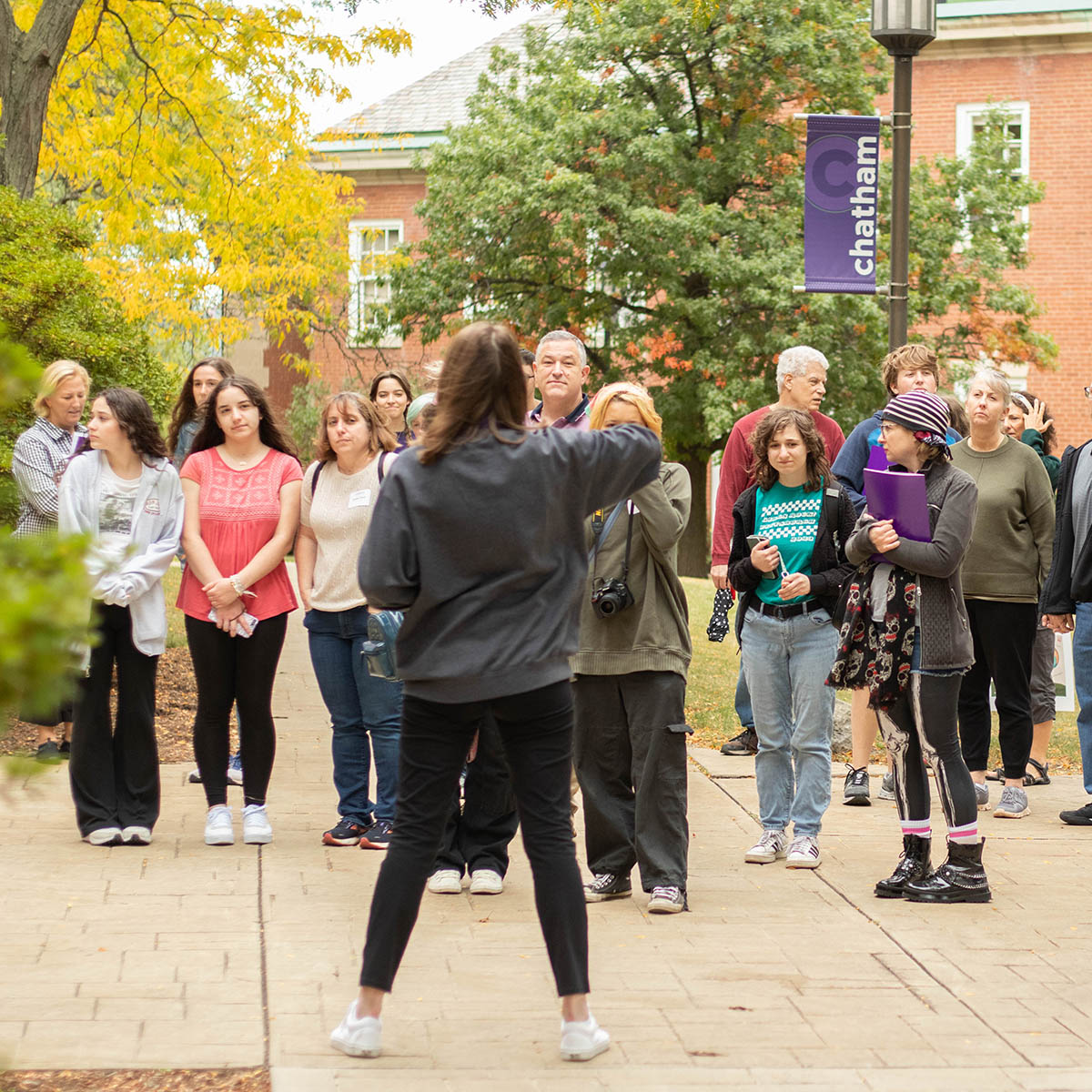 Students, parents, and others listen to a Chatham student worker during an admission open house in 2023. (Liam Lyons)