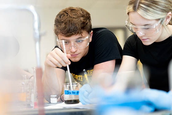 Students work in a science lab together
