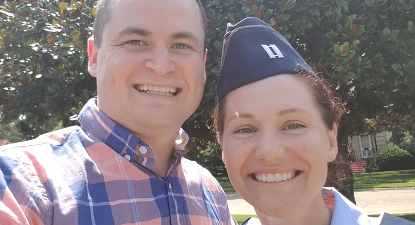 Selfie of a man and a woman in a military cap, smiling outside