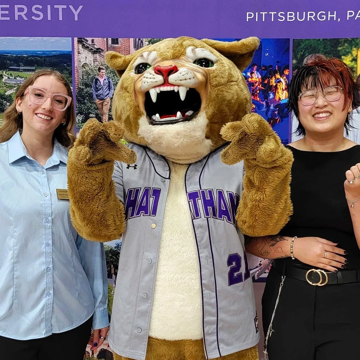 Two Chatham community members pose with Carson Cougar