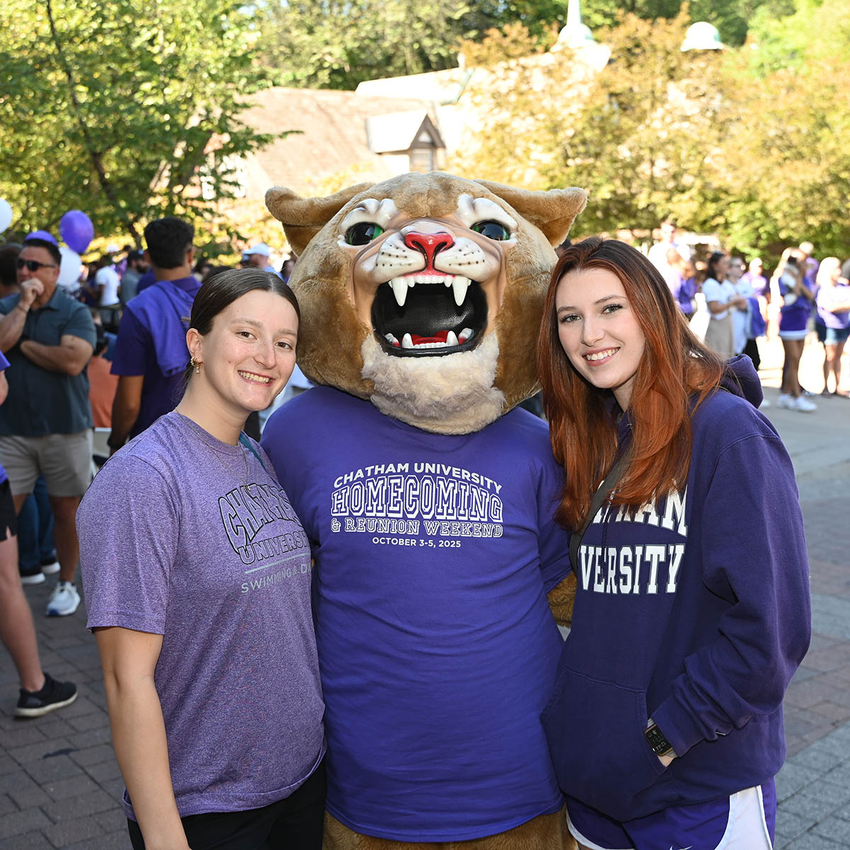 Chatham students pose with Carson the Cougar at Homecoming