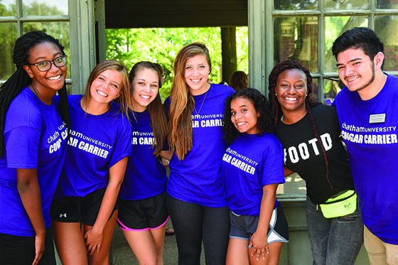 Photo of Chatham University students in purple Cougar Carrier shirts