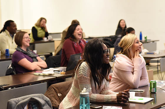 Photo of students in a lecture hall, paying attention to class