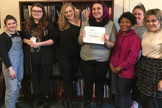 Photo of a group of female Chatham University students, posing together and smiling