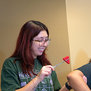 Two physician assistant graduate students testing reflexes together