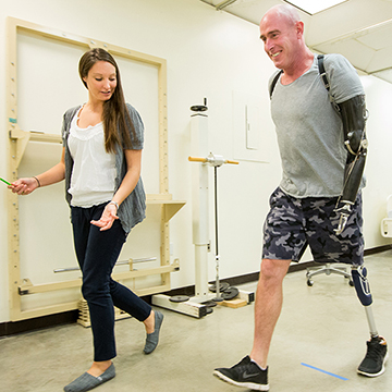 Physical Therapy student walking with an amputee