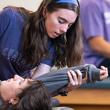 Physician Assistant Studies student testing reflexes in a lab