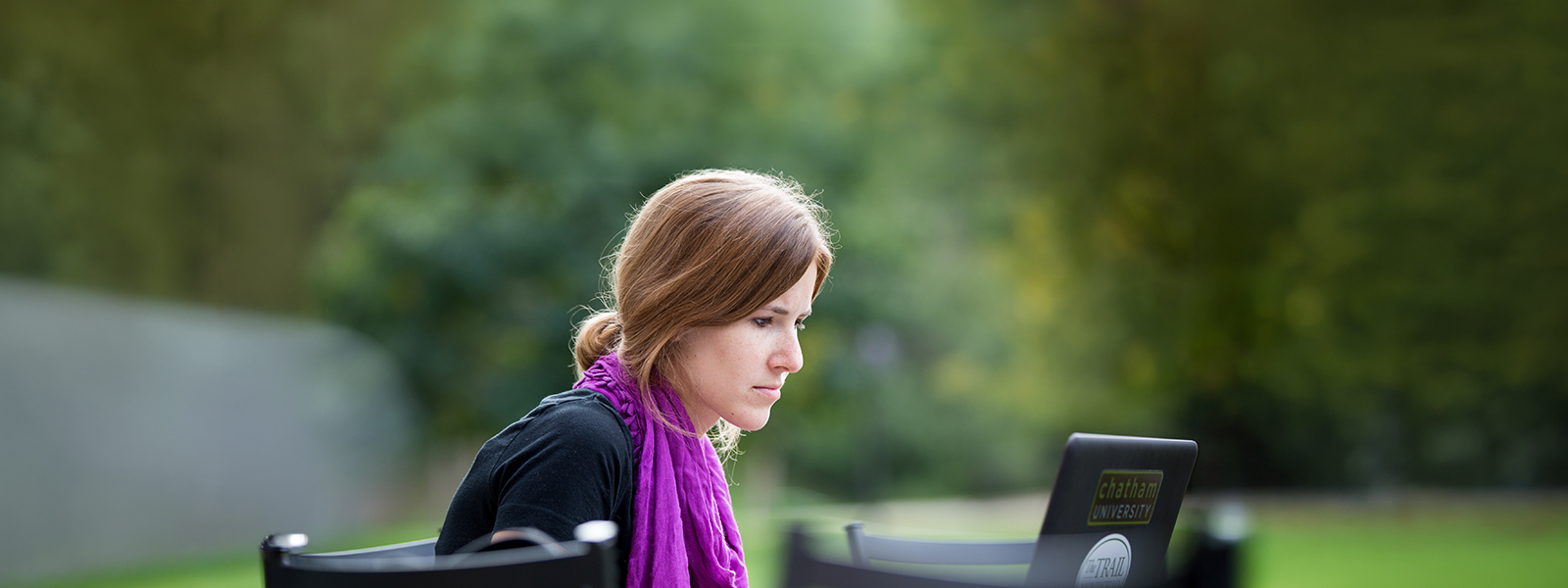 Chatham online student works on her laptop outside