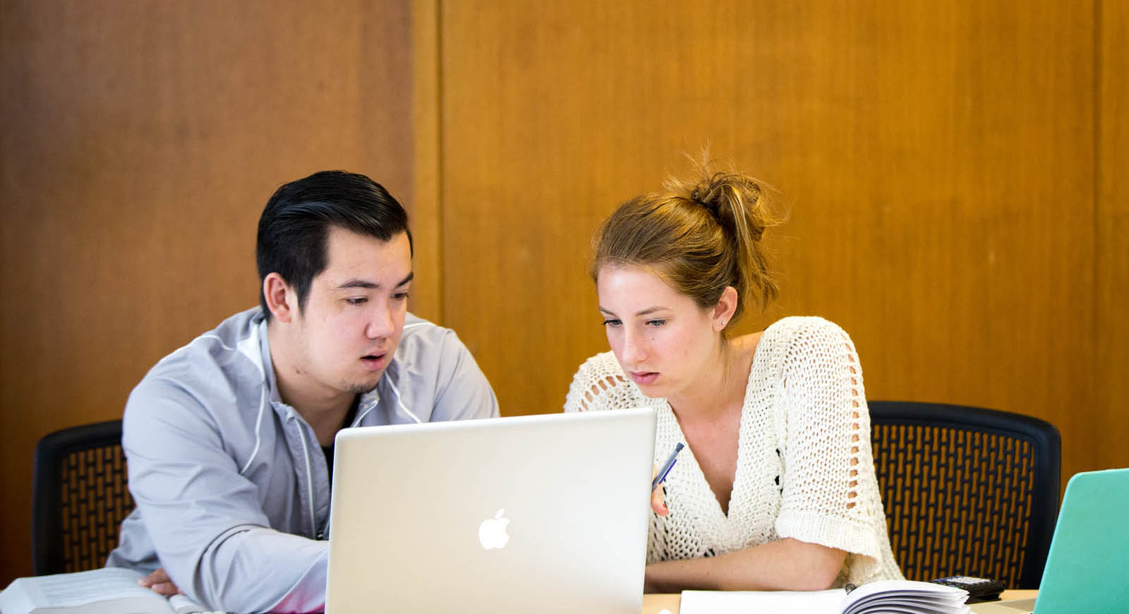 Photo of two Chatham University students looking at a laptop together