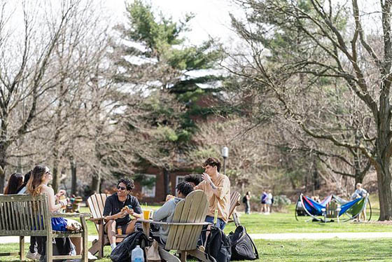 Photo of students sitting outside and hanging out on the Quad on Chatham University's Shadyside Campus