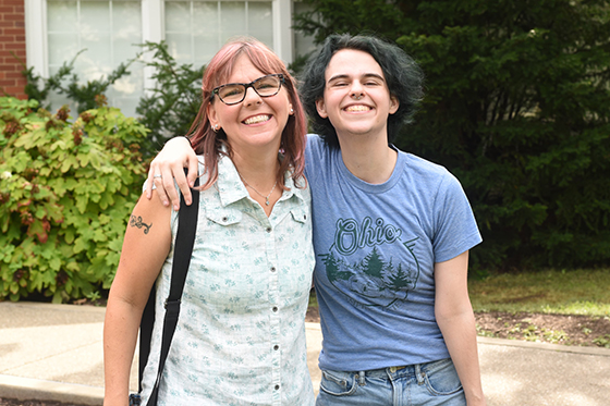 Photo of a Chatham University student and their parent smiling for the camera