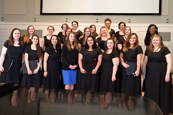 Photo of the Chatham Choir all wearing black, posing together for a photo