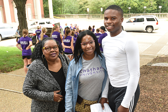 Photo of a Chatham University student posing outside with her mom and brother on family weekend. 
