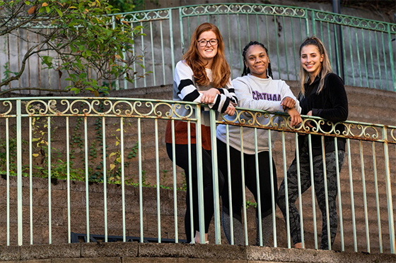 Photo of third-year entry-level Doctor of Occupational Therapy students Emily Smith, Dominique Peterson, and Kayla Raybuck posing against a fence at Vincentian Schenley Gardens